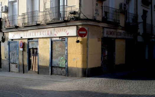 Closed storefront in Spain with shutters down, illustrating risks of buying a failing business