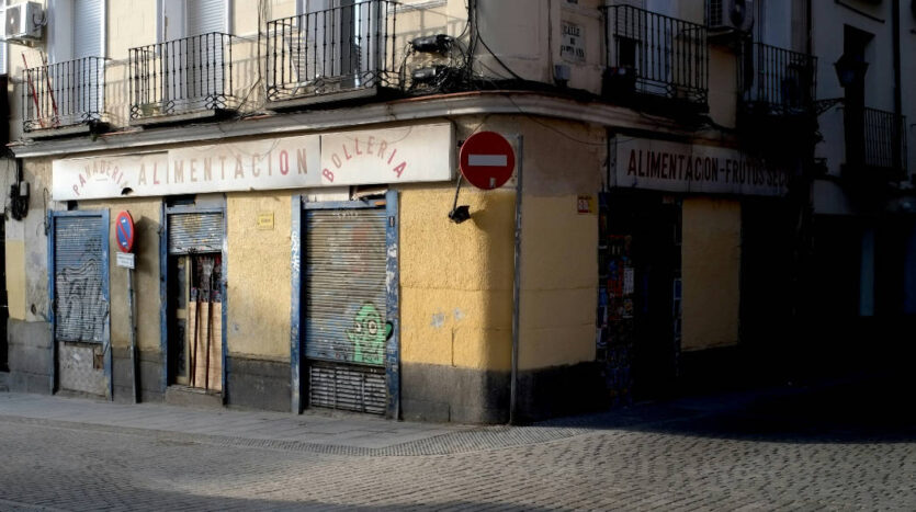 Closed storefront in Spain with shutters down, illustrating risks of buying a failing business