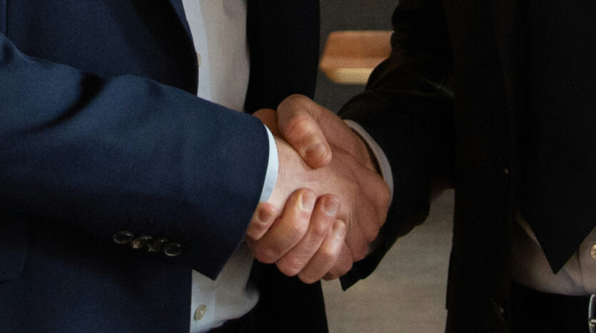 signing a business purchase agreement during a business acquisition in Spain