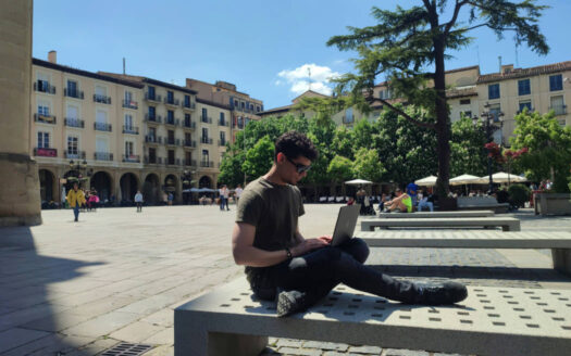 Entrepreneur working on a laptop in Spain while managing a business remotely