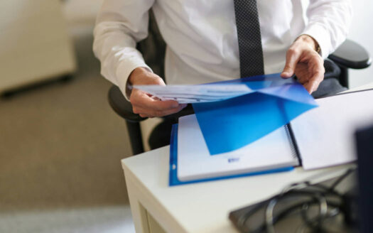 Professionals reviewing financial statements and legal documents during business due diligence in Spain